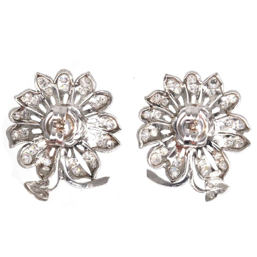 1940s 18ct white gold diamond flower cluster earrings with sparkling diamond petals and center.