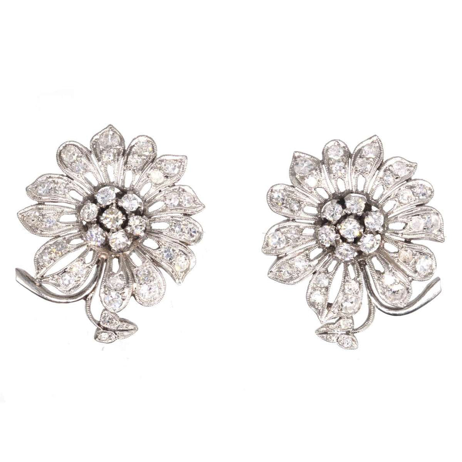 1940s 18ct white gold diamond flower cluster earrings, featuring sparkling diamond petals and a stunning central diamond cluster.