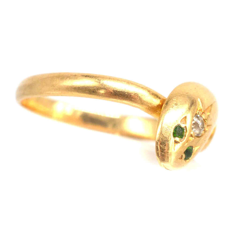 Edwardian 18ct gold snake ring featuring diamond and green garnet eyes for a stunning vintage jewelry look.