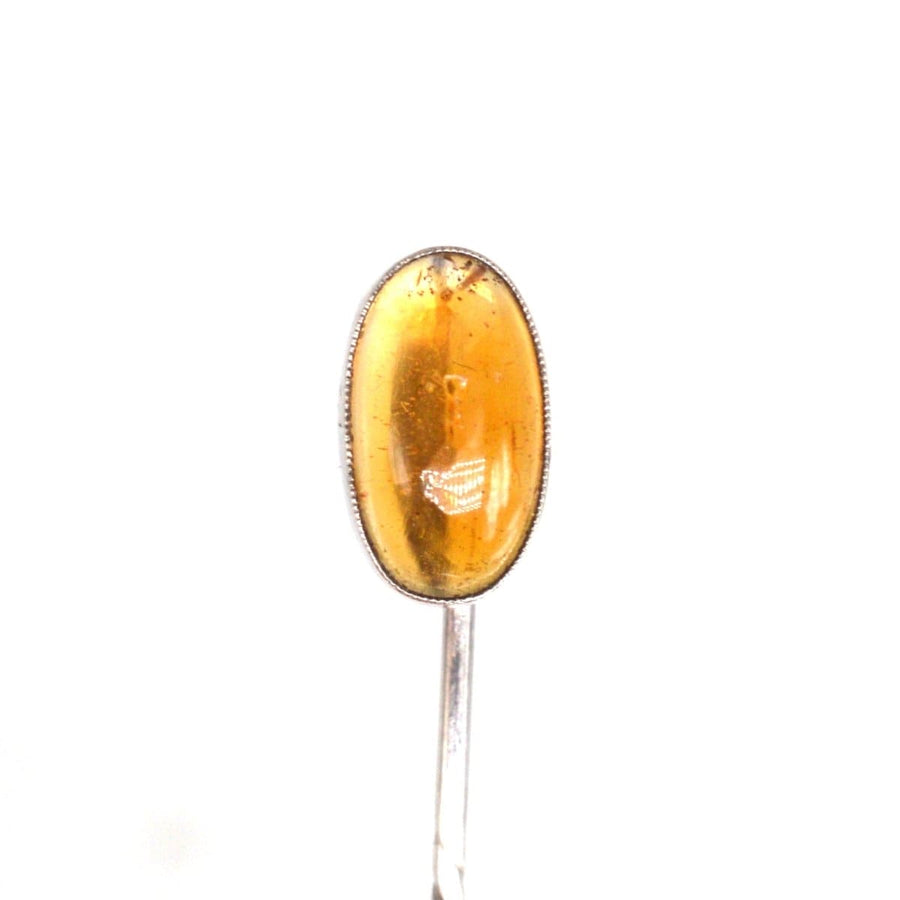 Art Deco silver tie pin featuring a striking natural amber stone, circa 1920s, perfect for adding elegance to any outfit.