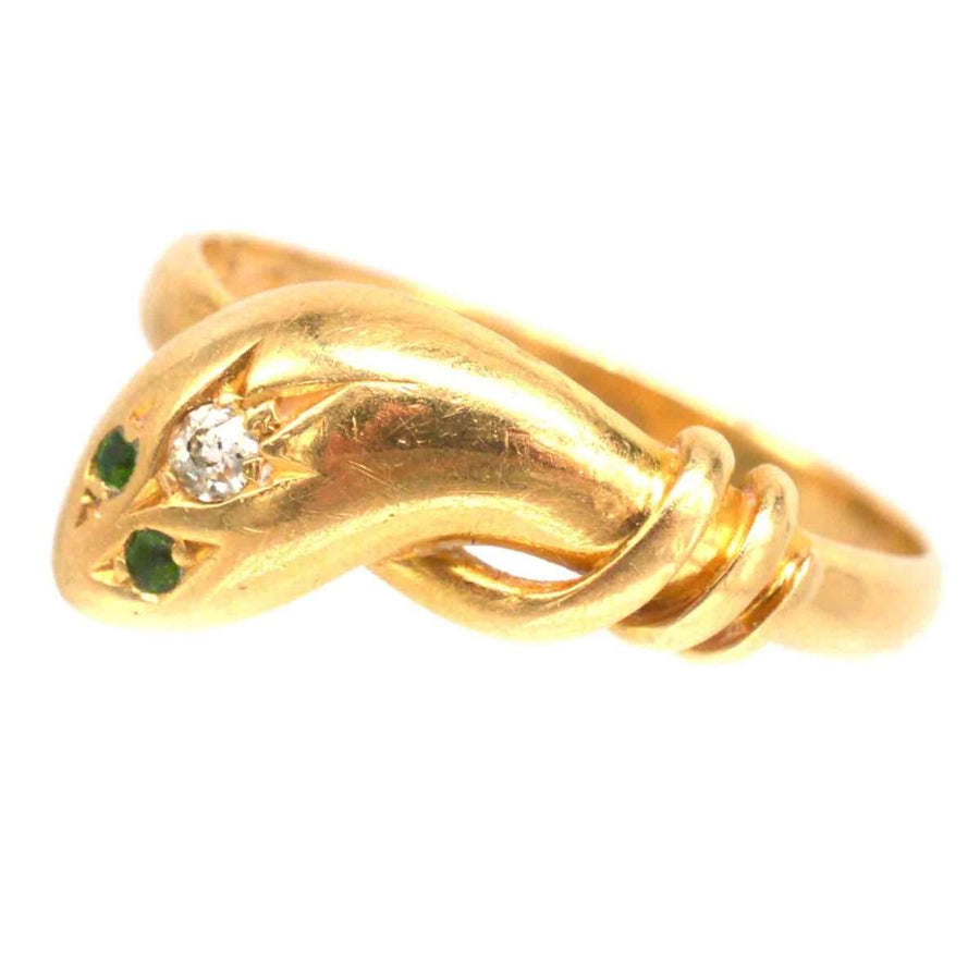 Edwardian 18ct gold snake ring featuring diamond and green garnet eyes, showcasing intricate craftsmanship.