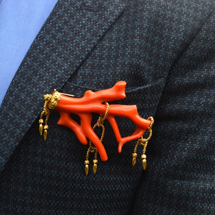 Large red coral branch brooch with gold rope tassels on a suit lapel, vintage Victorian style