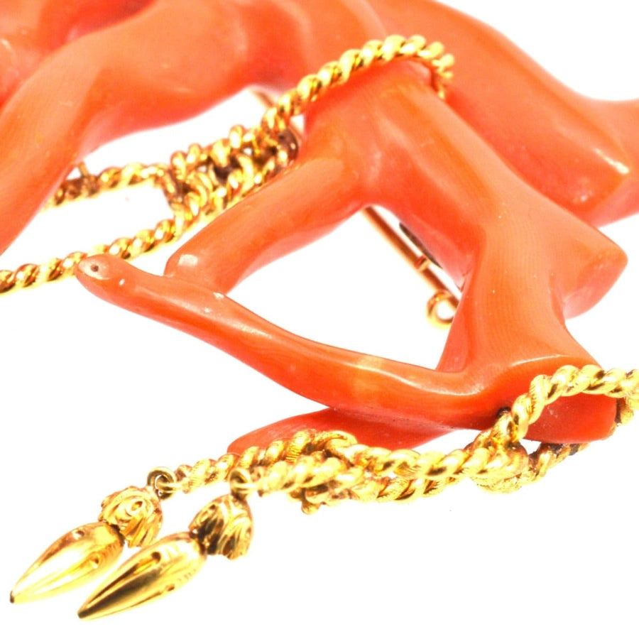 Large antique red coral brooch with gold rope tassel details, showcasing intricate rocaille design.