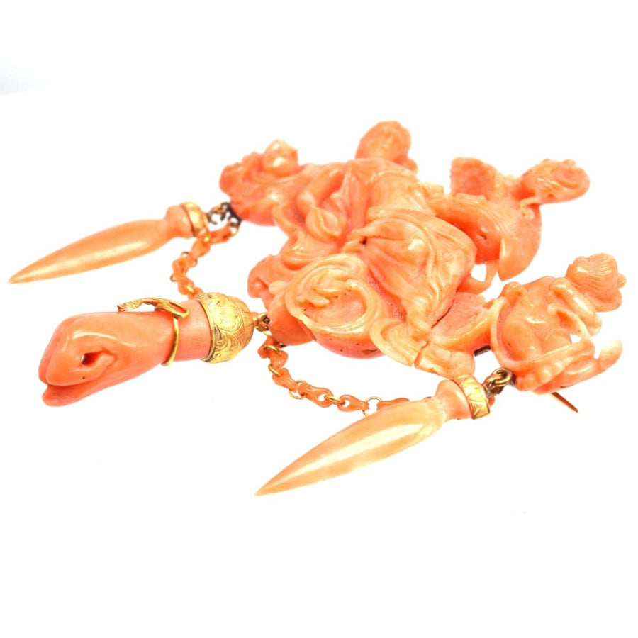 Antique carved coral brooch depicting goddess Hebe, Zeus, and Cupid, showcasing timeless elegance and craftsmanship.
