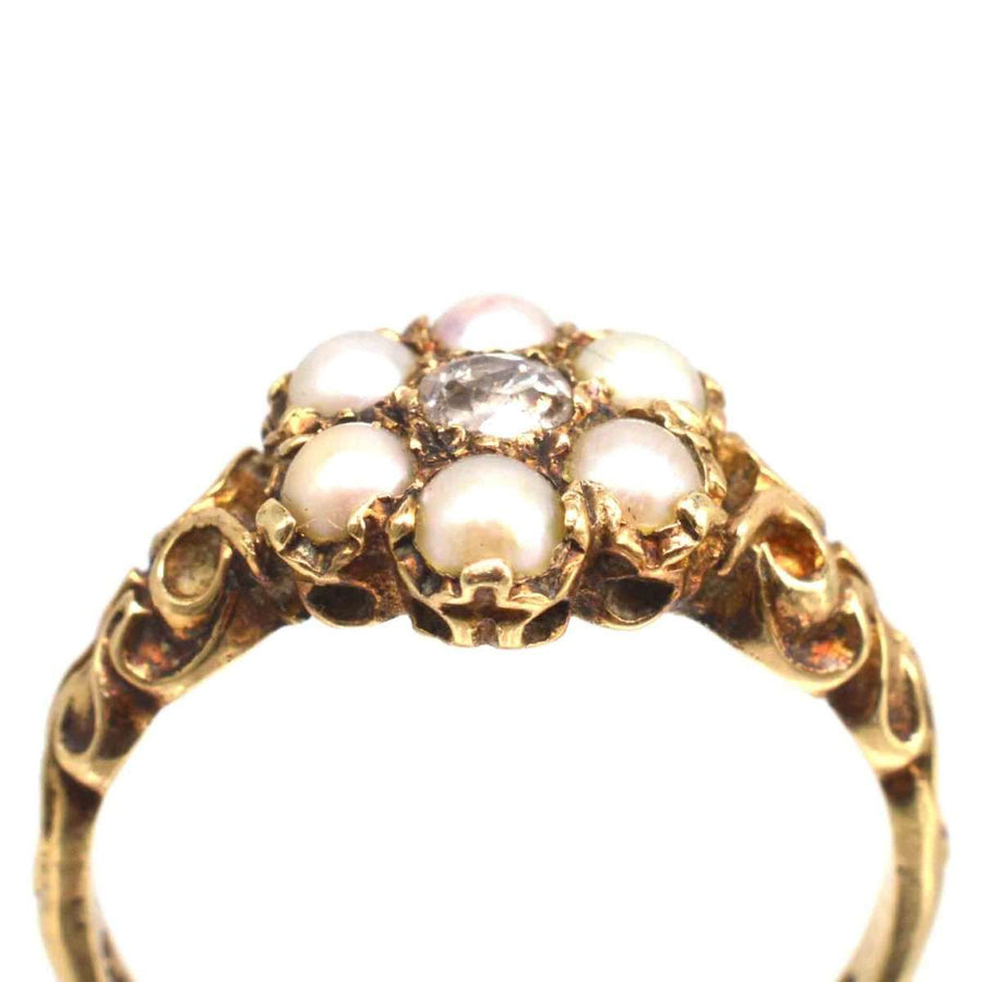 Late Victorian 9ct gold cluster ring with creamy split pearls and pinkish diamond centerpiece from the 1860s.