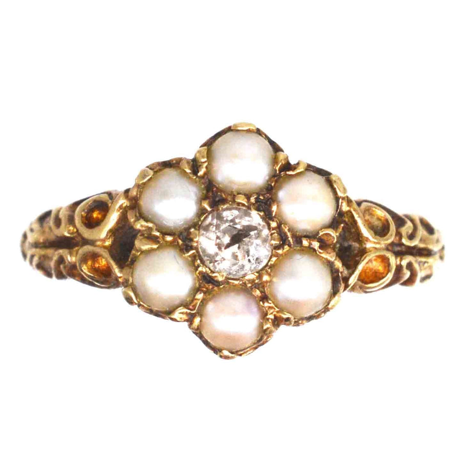 Late Victorian 9ct gold cluster ring with split pearls and old mine cut diamond, featuring a classic romantic design.