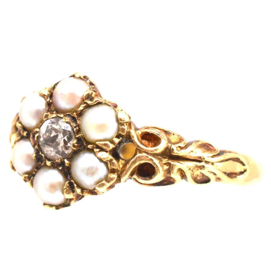 Late Victorian 9ct gold cluster ring with split pearls and old mine cut diamond, showcasing vintage elegance.