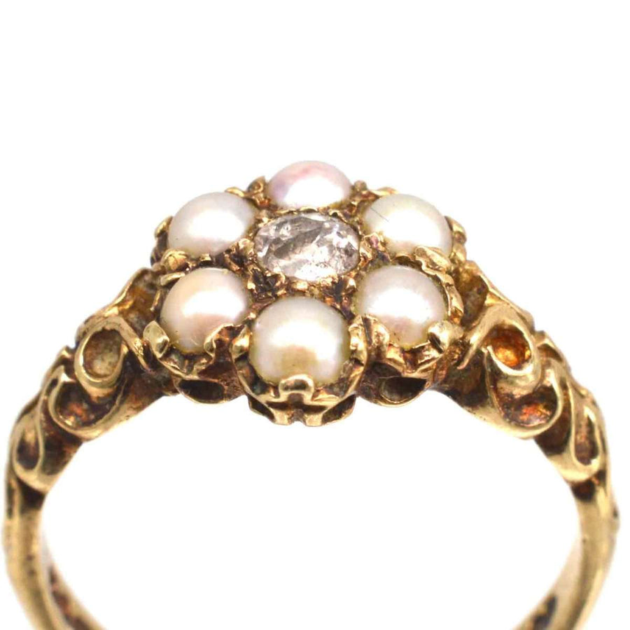 Late Victorian 9ct gold ring featuring split pearls and an old mine cut diamond, showcasing classic cluster design.