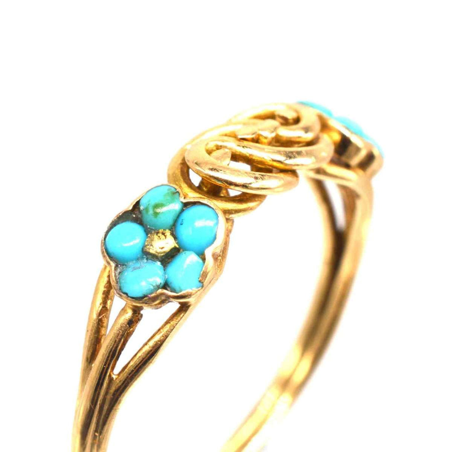 Regency 18ct gold ring featuring turquoise forget-me-not flowers and a gold lover’s knot from circa 1830.
