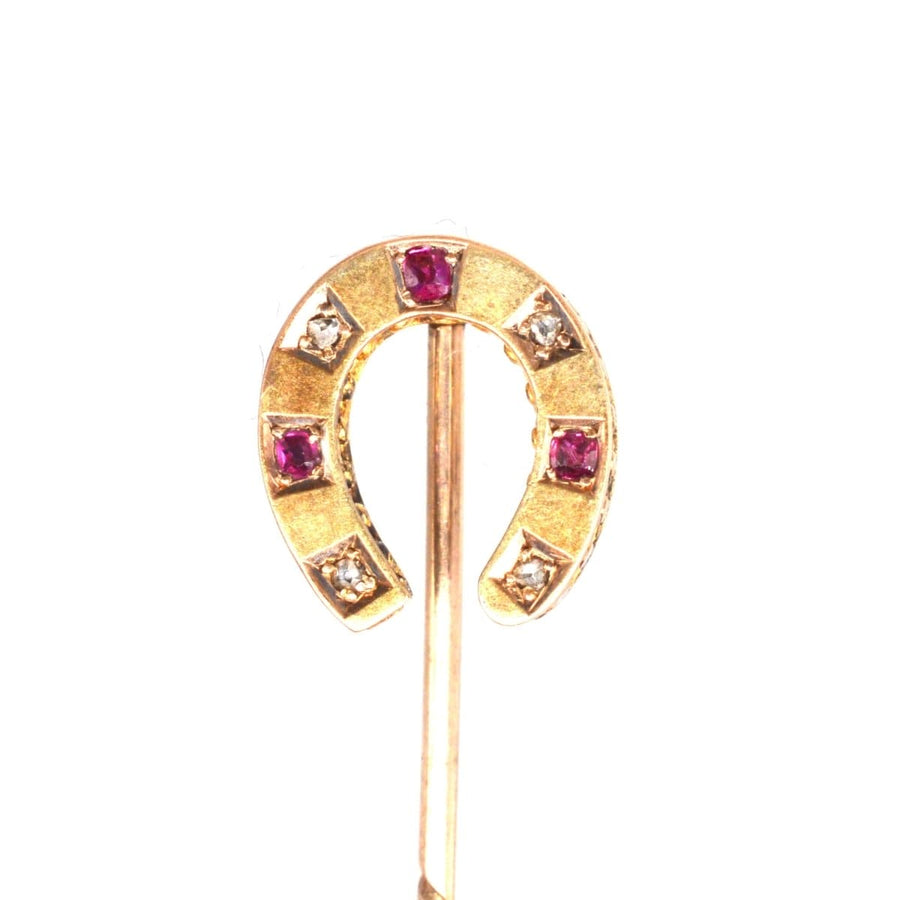 Victorian 15ct gold horseshoe tie pin with rubies and diamonds, symbolizing luck and love.