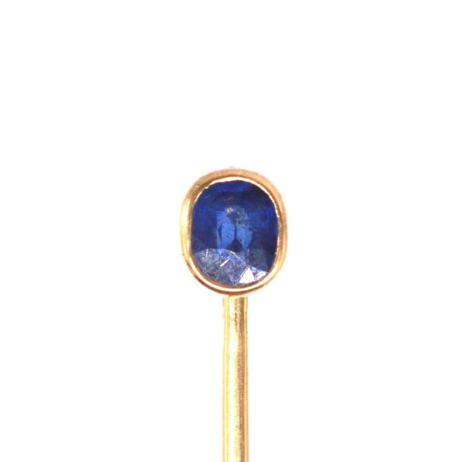 Austro-Hungarian 14ct gold tie pin featuring a vibrant blue sapphire stone, showcasing fine craftsmanship.