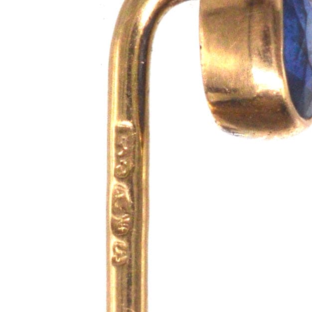Close-up view of early 20th century Austro-Hungarian 14ct gold tie pin showcasing the vibrant blue sapphire and hallmark.