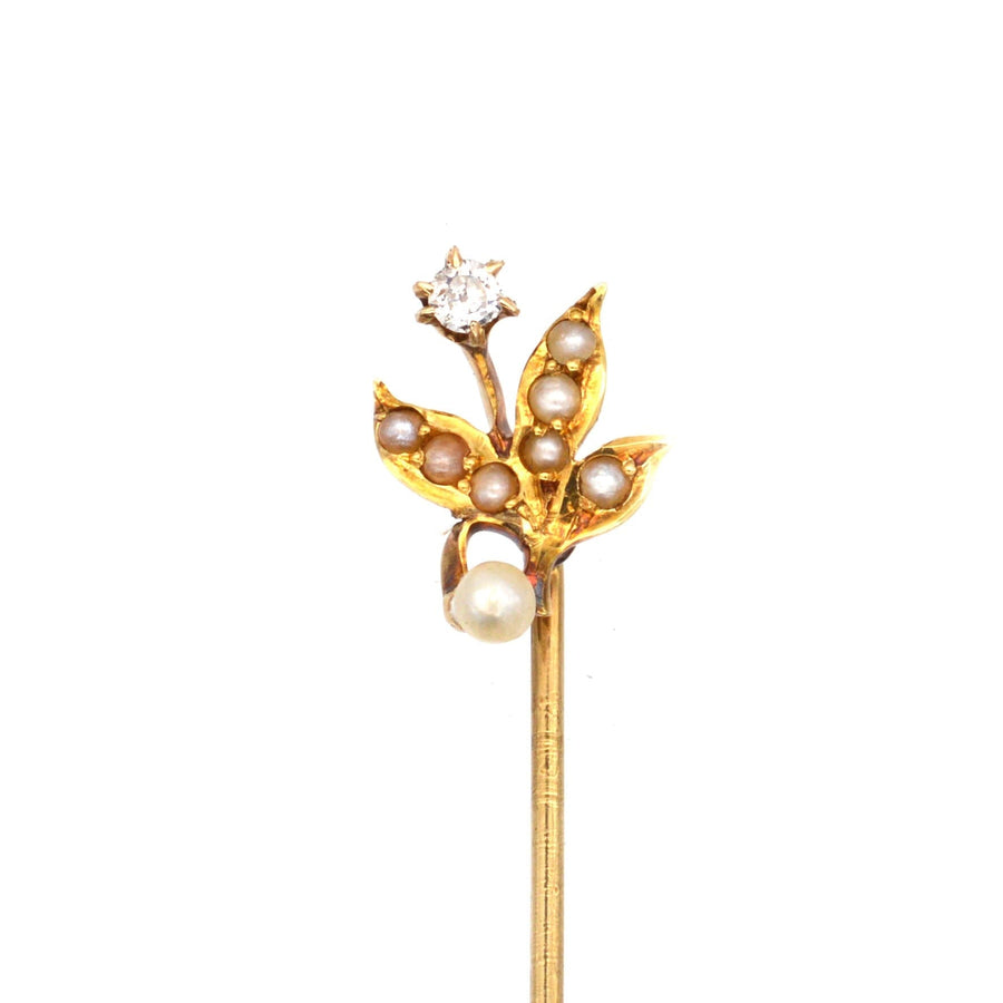 Edwardian 14ct gold tie pin featuring pearl leaves and a diamond flower, dating from the 1900s.