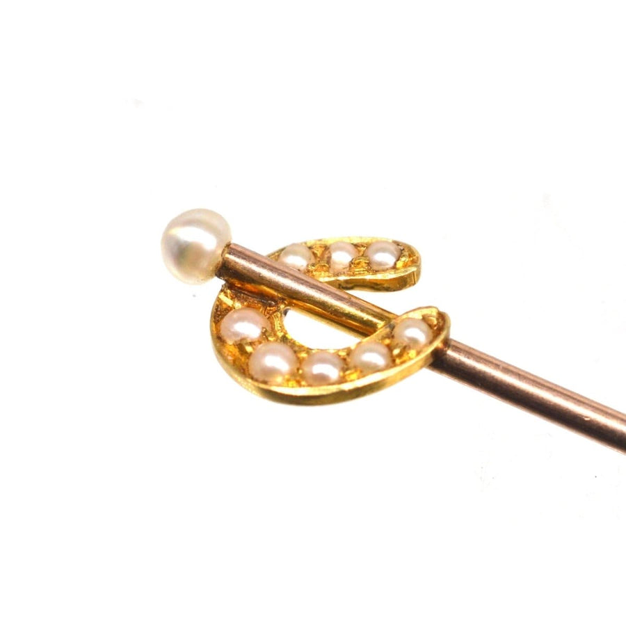 Edwardian 15ct gold horseshoe tie pin featuring pearls, symbolizing good luck and protection.