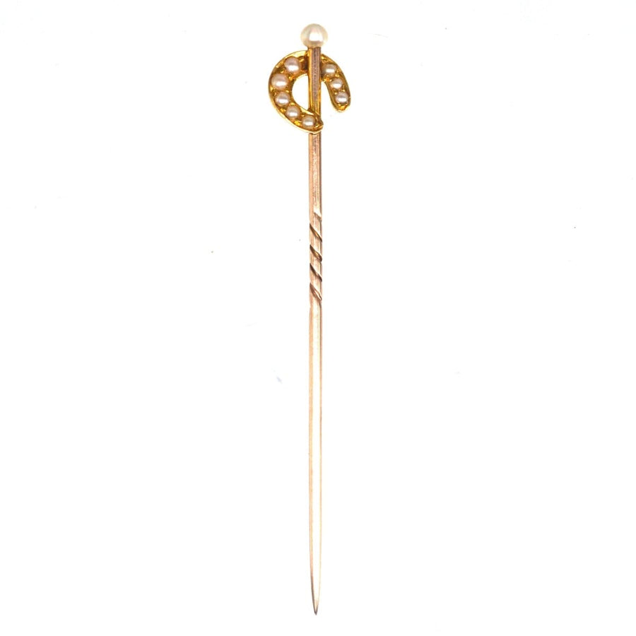 Edwardian 15ct gold pearl horseshoe tie pin with natural pearl, symbolizing luck and protection.