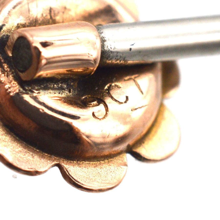Close-up of a vintage 9ct gold tie pin featuring an engraved design and pin mechanism, circa 1880s.