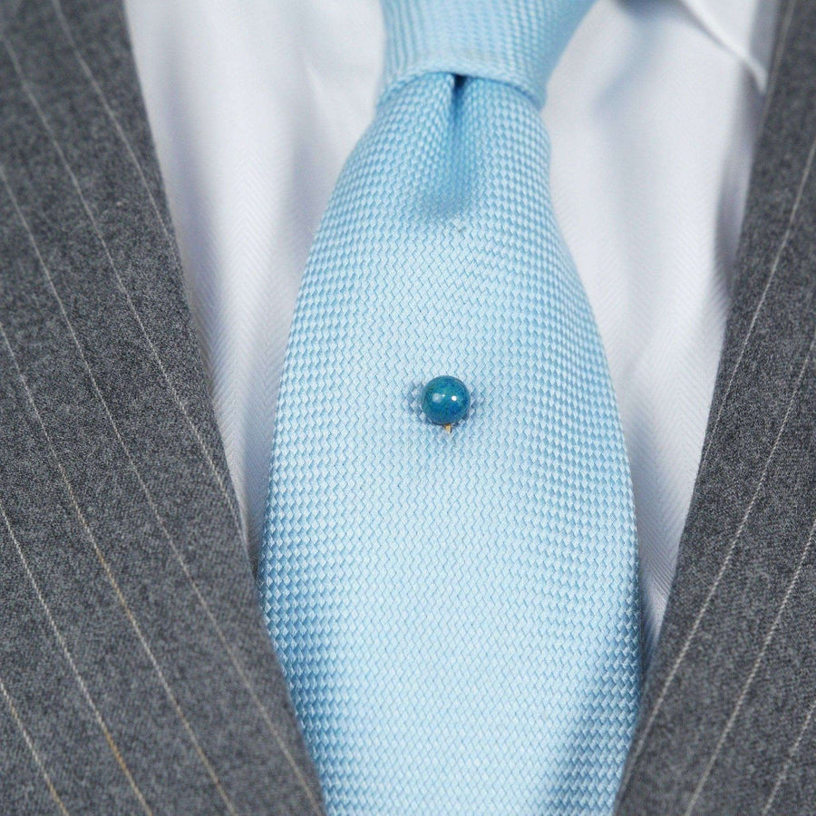 Victorian gold lapis lazuli sphere tie pin on light blue tie, circa 1860-1880, perfect for formal attire.